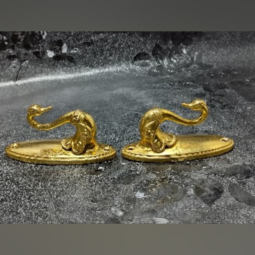 2 Gold Swan curtain tieback hooks.